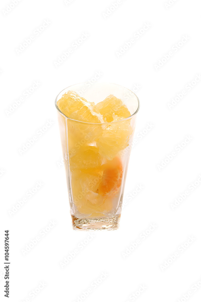 Pomelo and tangerine slices citrus in long glass with water drops isolated toned Pomelo and tangerine slices citrus in long glass with water drops isolated toned