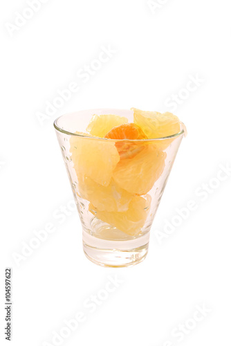 Pomelo and tangerine slices citrus in glass with water drops isolated toned