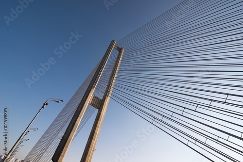 Fototapeta Naklejka Na Ścianę i Meble -  bridge steel ropes constructions on sky  background