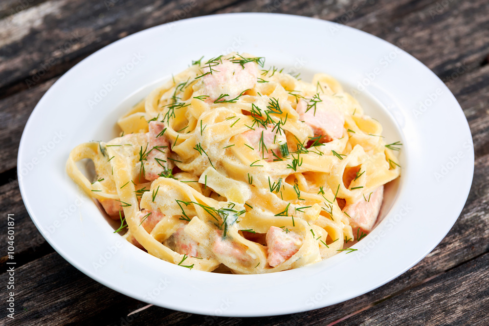 tasty pasta with salmon, dill on plate