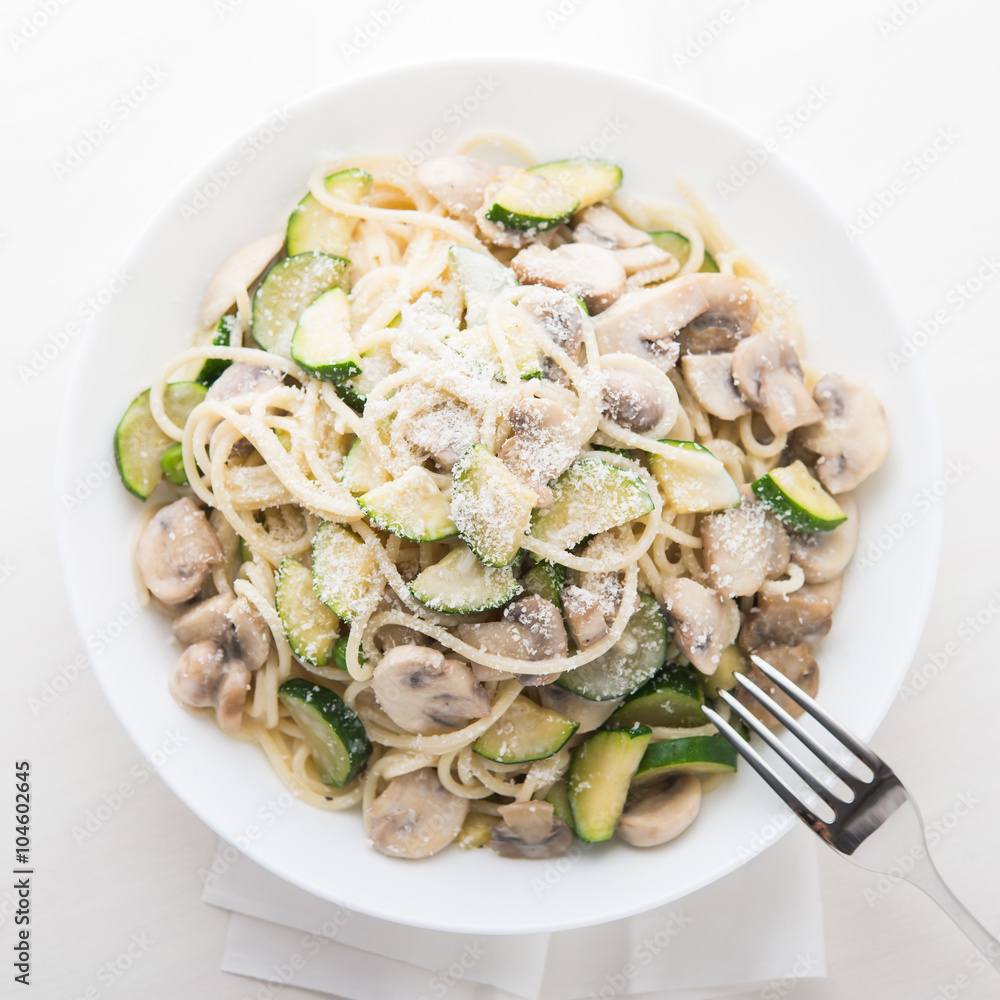 Pasta ( spaghetti ) with zucchini, mushrooms, creamy sauce and parmesan top view. Pasta ( spaghetti ) with zucchini, mushrooms, creamy sauce and parmesan top view.