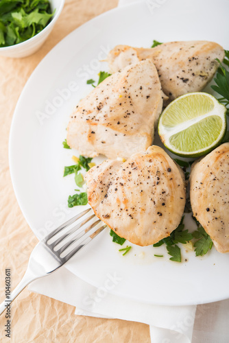 Chicken breasts with parsley and citrus top view. Healthy food.