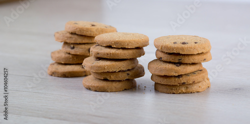 Chocolate cookies on wooden table. Cookies with chocolate and nuts