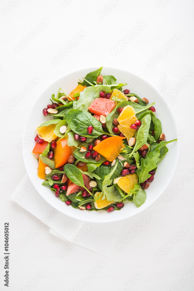 Fresh salad with fruits and greens on white background top view. Healthy food. Fresh salad with fruits and greens on white background top view. Healthy food.