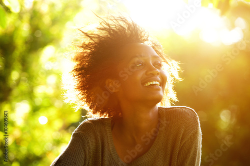 Beautiful african american woman smiling with sunset