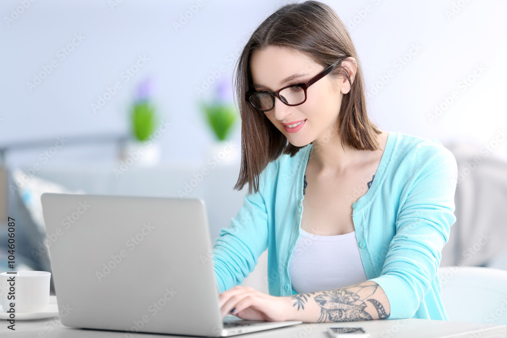 Woman sitting at the table and working with laptop Woman sitting at the table and working with laptop