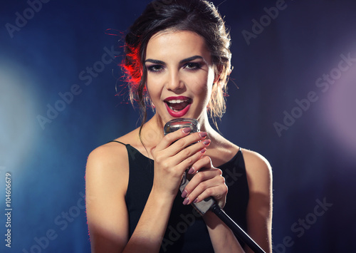 Young pretty woman singing, close up