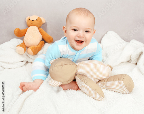 Adorable baby with teddy be...