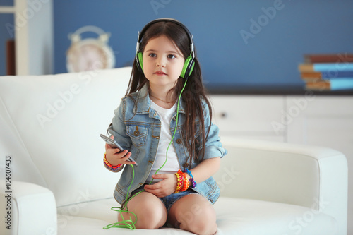 Cute little girl listening ...