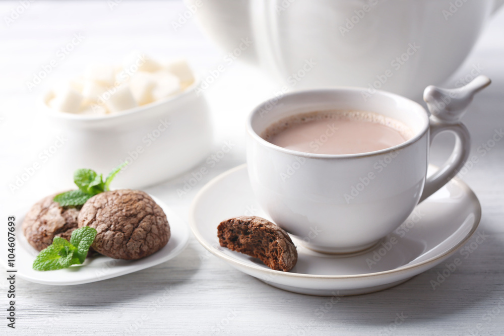Cup of cocoa with chocolate chip cookies and mint on light background Cup of cocoa with chocolate chip cookies and mint on light background