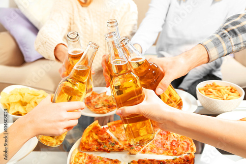 Friendly party with hot pizza and drinks, close up