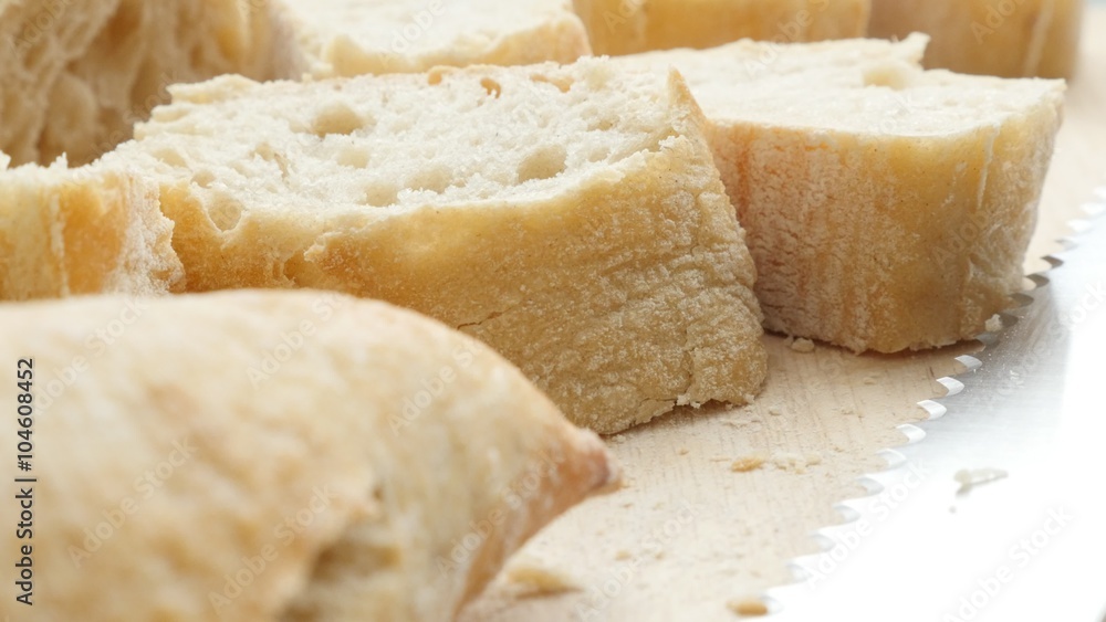 Long loaf of French baguette bread cutted on smaller pieces 4K 2160p 30fps UltraHD footage - Traditional bread in France baguette on table with knife 4K 3840X2160 UHD video Long loaf of French baguette bread cutted on smaller pieces 4K 2160p 30fps UltraHD footage - Traditional bread in France baguette on table with knife 4K 3840X2160 UHD video