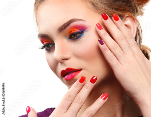 Beautiful girl with colorful makeup and manicure  isolated on white