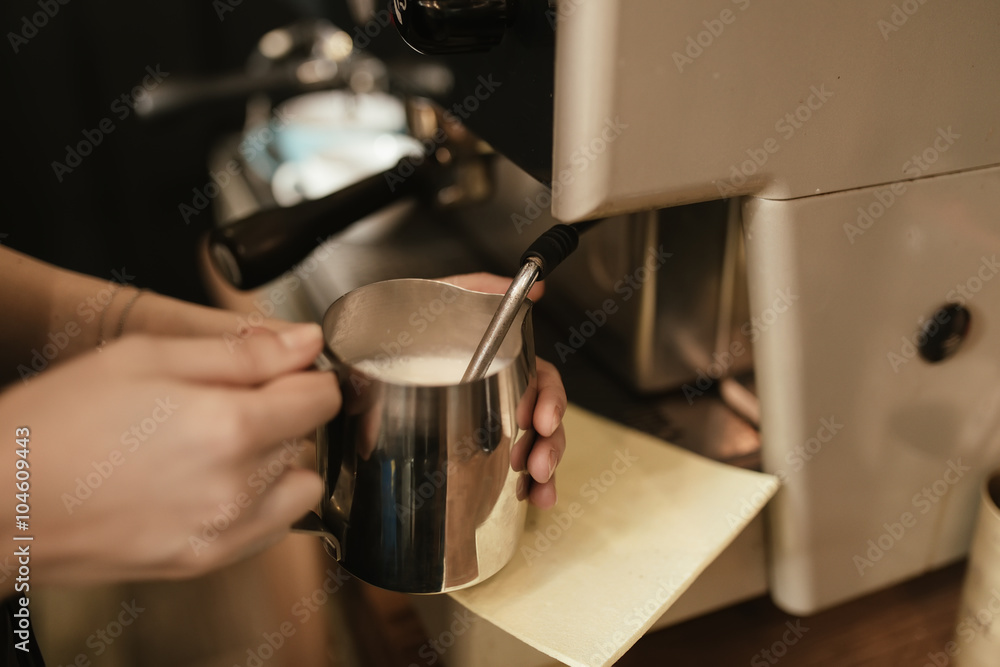 Barista steaming milk in cafe Barista steaming milk in cafe