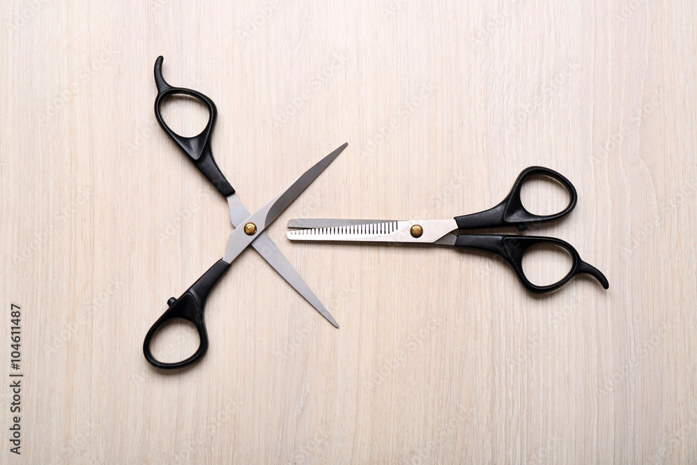 Barber set with two scissors on light wooden table Barber set with two scissors on light wooden table