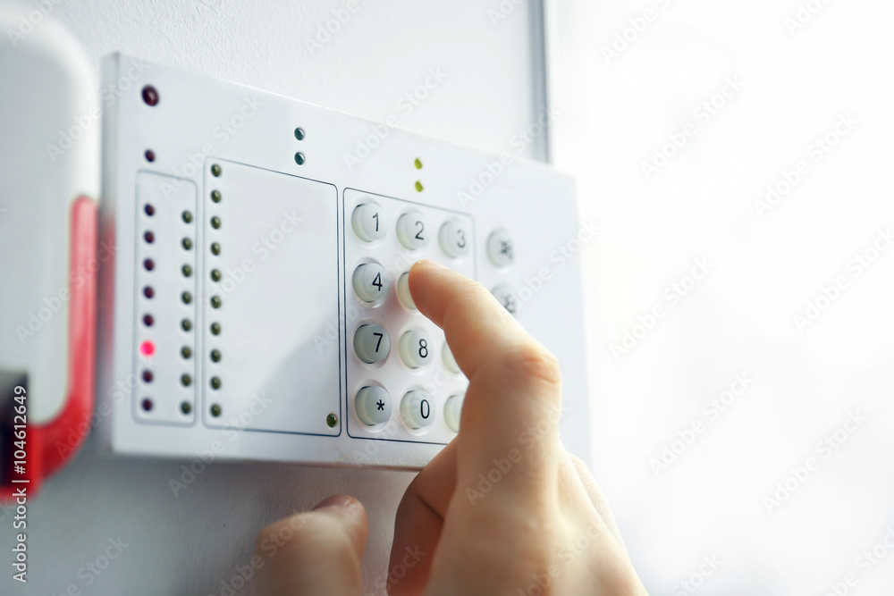 Security alarm keypad with male hand, closeup Security alarm keypad with male hand, closeup