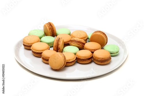 A few macarons on the dish are isolated on white
