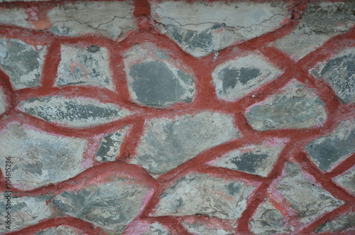 Stone wall with dark red seam