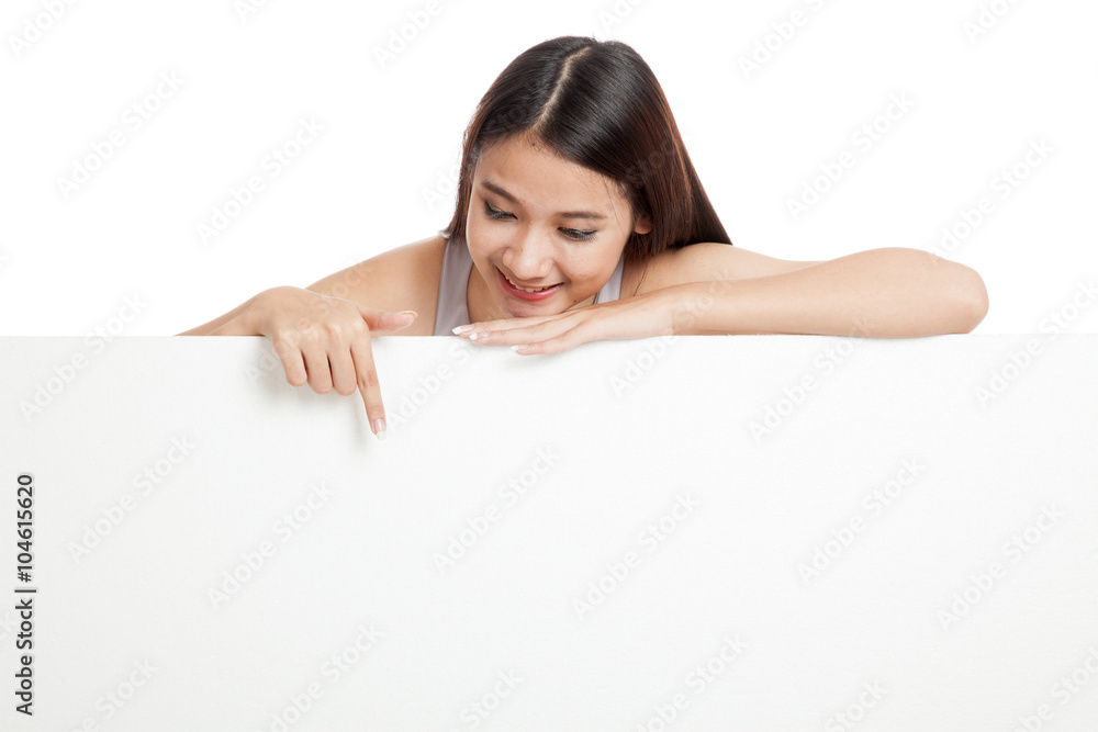 Young Asian woman point down behind a blank sign Young Asian woman point down behind a blank sign