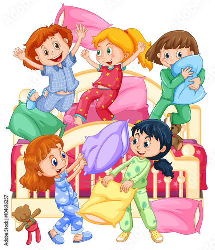 Girls playing pillow fight at slumber party
