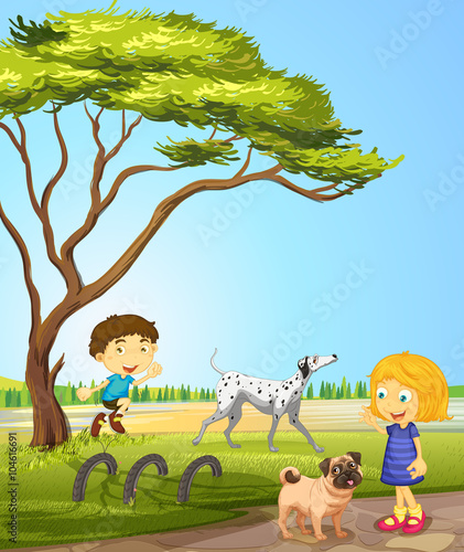 Children playing with dogs in the park