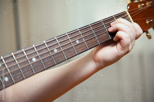 Little boy is playing the guitar