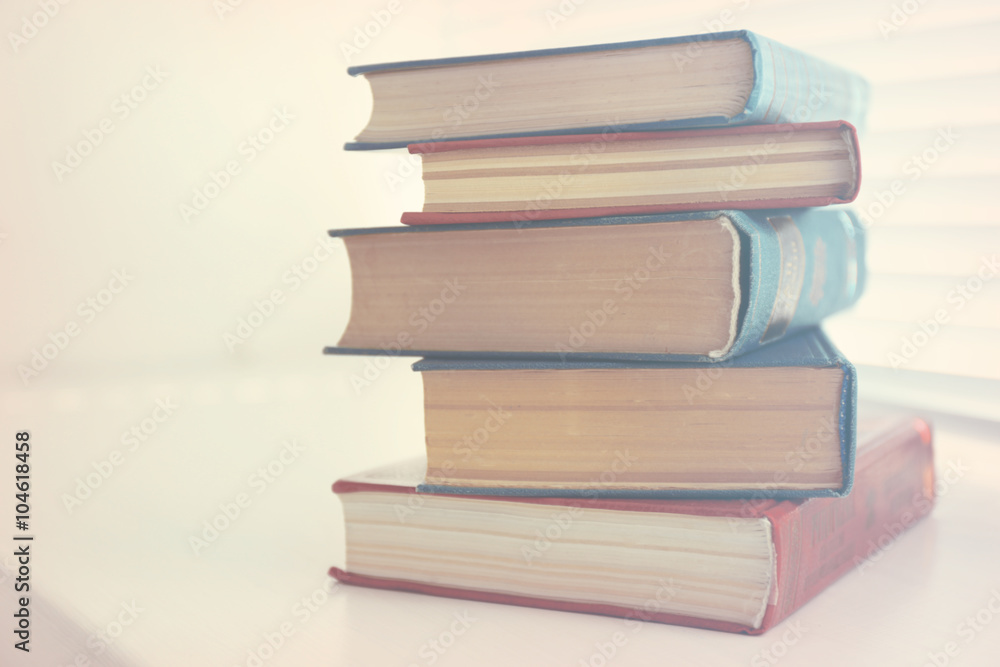 Books on white windowsill, close up Books on white windowsill, close up