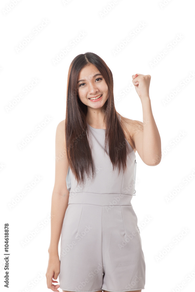 Successful young Asian woman hold fist up Successful young Asian woman hold fist up