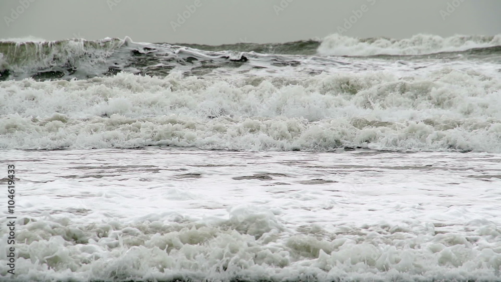 Huge Storm Waves In Super Slow Motion. Winter storms hitting the British coast as large waves crash on a sandy beach Huge Storm Waves In Super Slow Motion. Winter storms hitting the British coast as large waves crash on a sandy beach