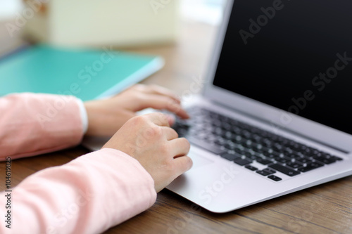 Woman using laptop at the table in office