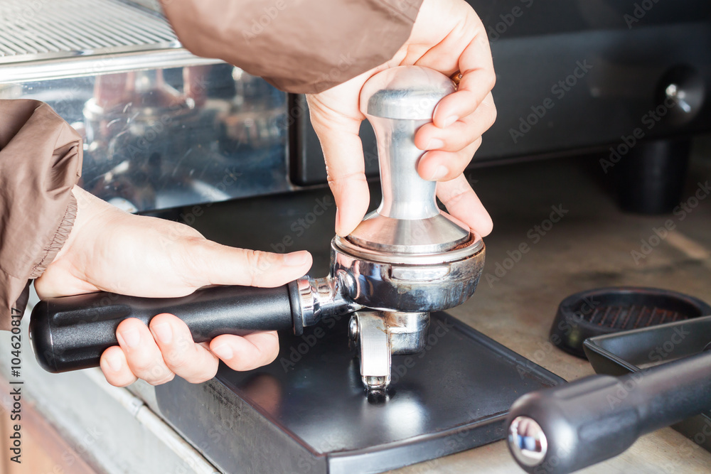 Barista with tamper for making espresso