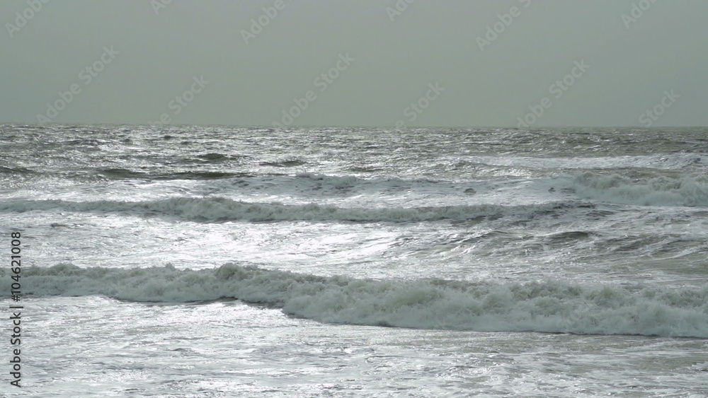 Huge Storm Waves In Super Slow Motion. Winter storms hitting the British coast as large waves crash on a sandy beach Huge Storm Waves In Super Slow Motion. Winter storms hitting the British coast as large waves crash on a sandy beach