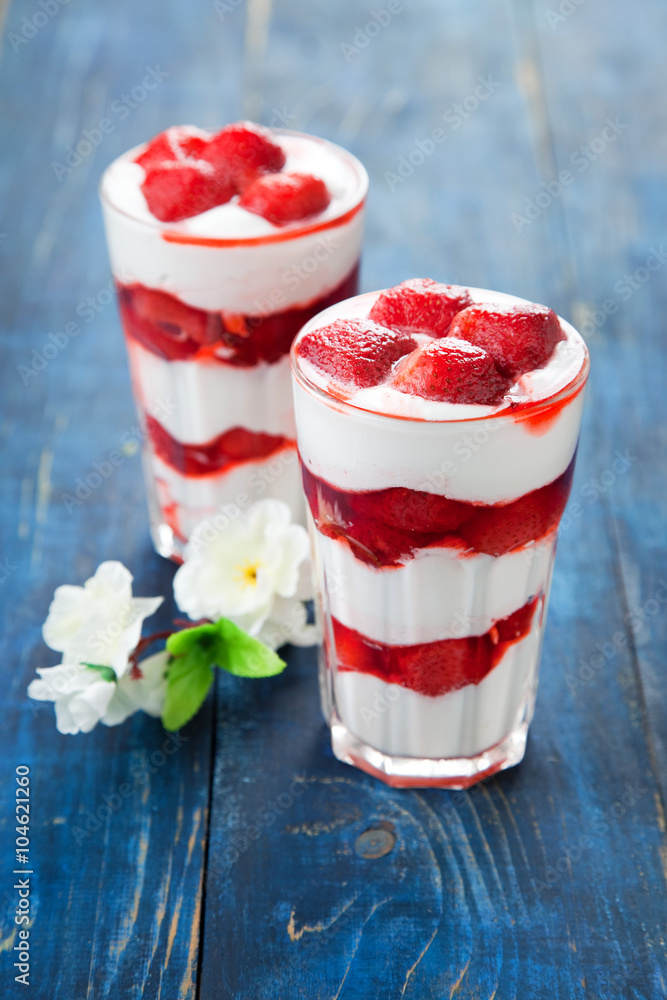 Dessert with strawberry sauce in glass, selective focus Dessert with strawberry sauce in glass, selective focus