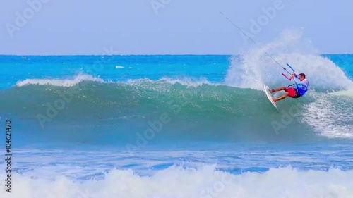 Extreme sports video background. Kitesurfing athlete rides on high waves on sea