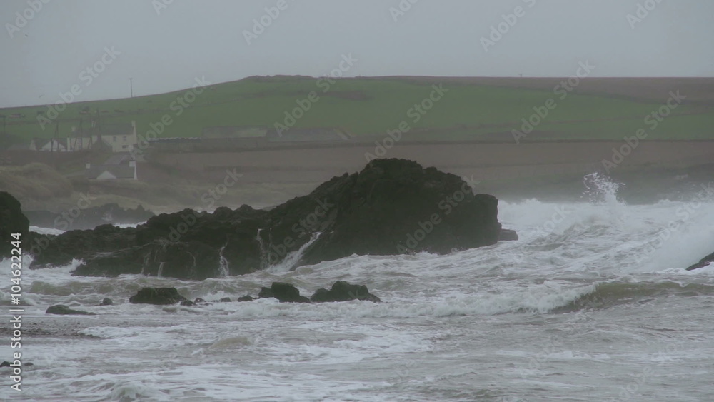 Storm Waves Crashing On Large Rocks As The Waves Hit Shore. Slow motion footage of large storm waves crashing on rocky cliffs. Storm Waves Crashing On Large Rocks As The Waves Hit Shore. Slow motion footage of large storm waves crashing on rocky cliffs.