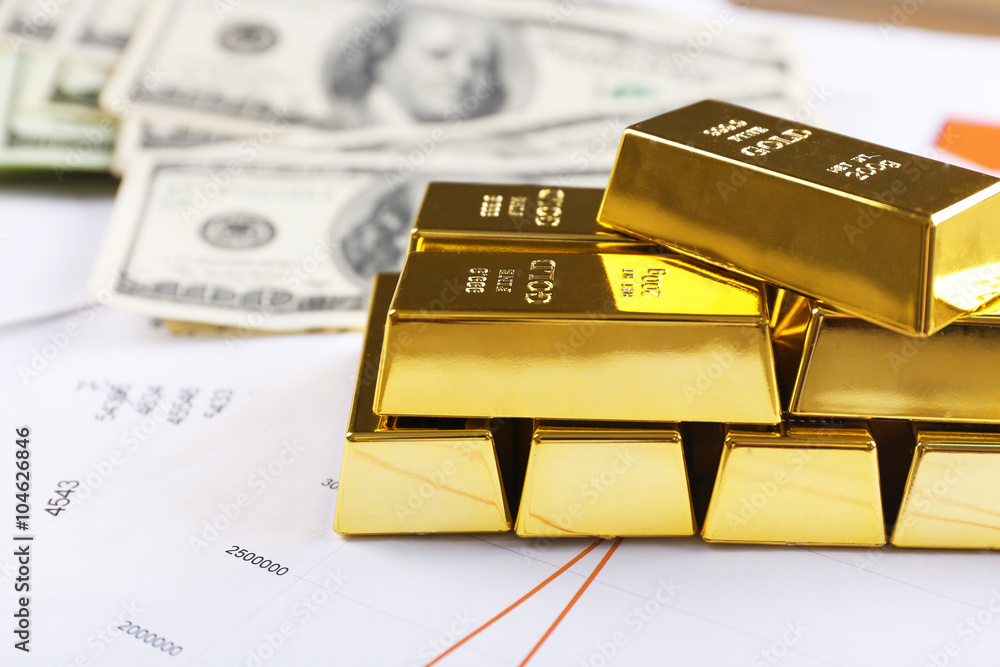 Gold bars with dollar banknotes on paper background Gold bars with dollar banknotes on paper background
