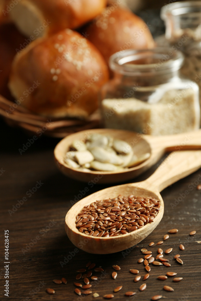 Composition of seeds and buns on wooden table background, closeup Composition of seeds and buns on wooden table background, closeup