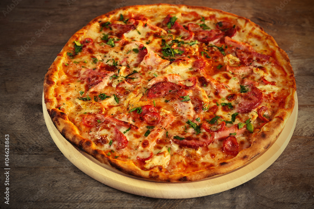 Delicious pizza on wooden table Delicious pizza on wooden table