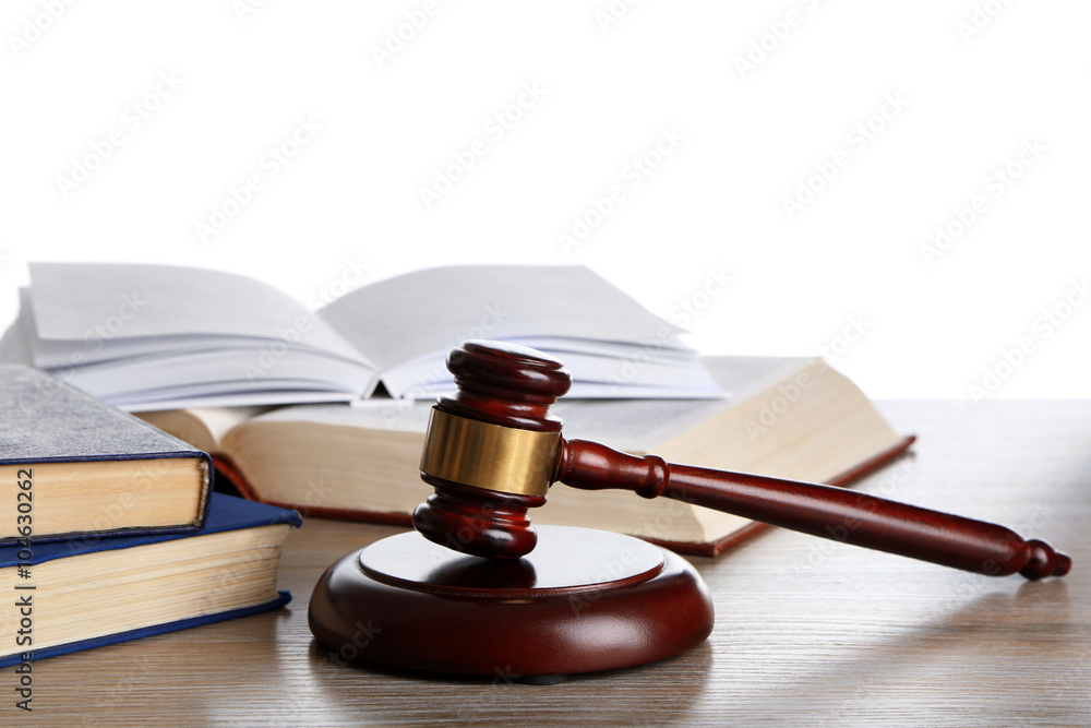 Wooden gavel with books on white background Wooden gavel with books on white background