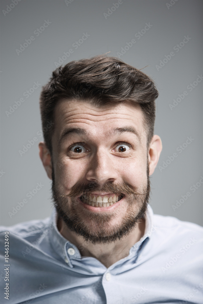 Man is looking scared. Over gray background Man is looking scared. Over gray background