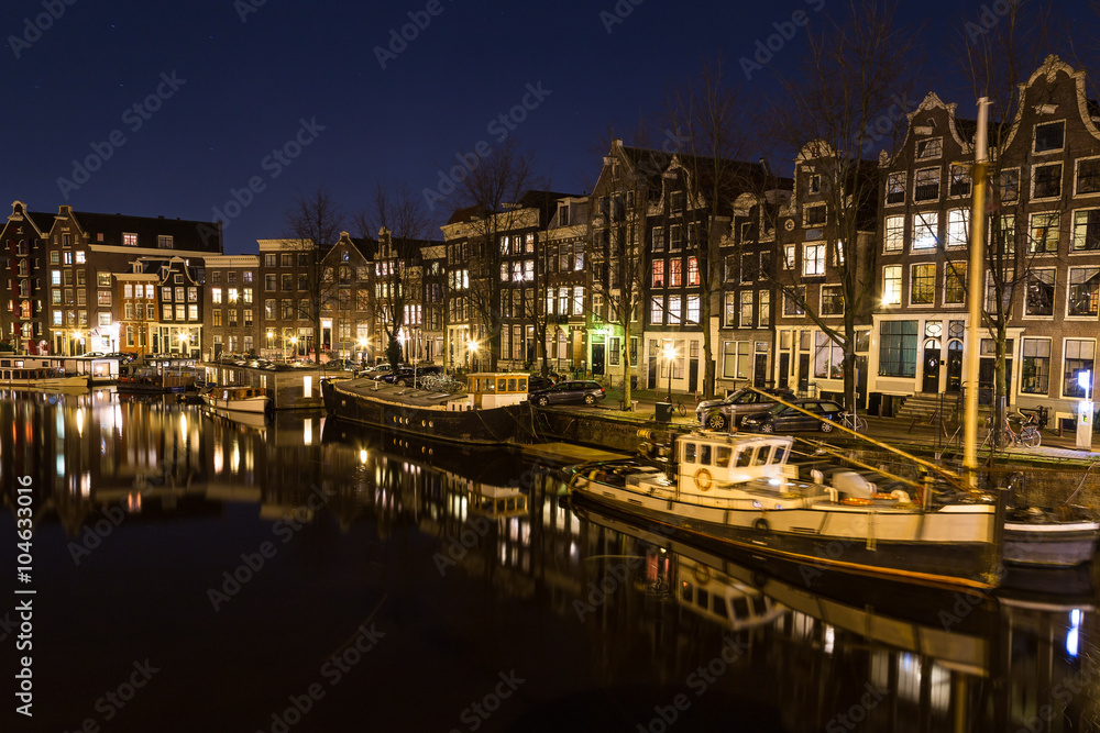 View along the Waalseilandgracht Canal in Amsterdam at night