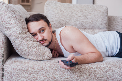 man with the beard carries out weekend on couch photo