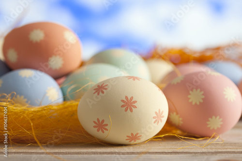 Easter eggs in pastel color on blue sky background