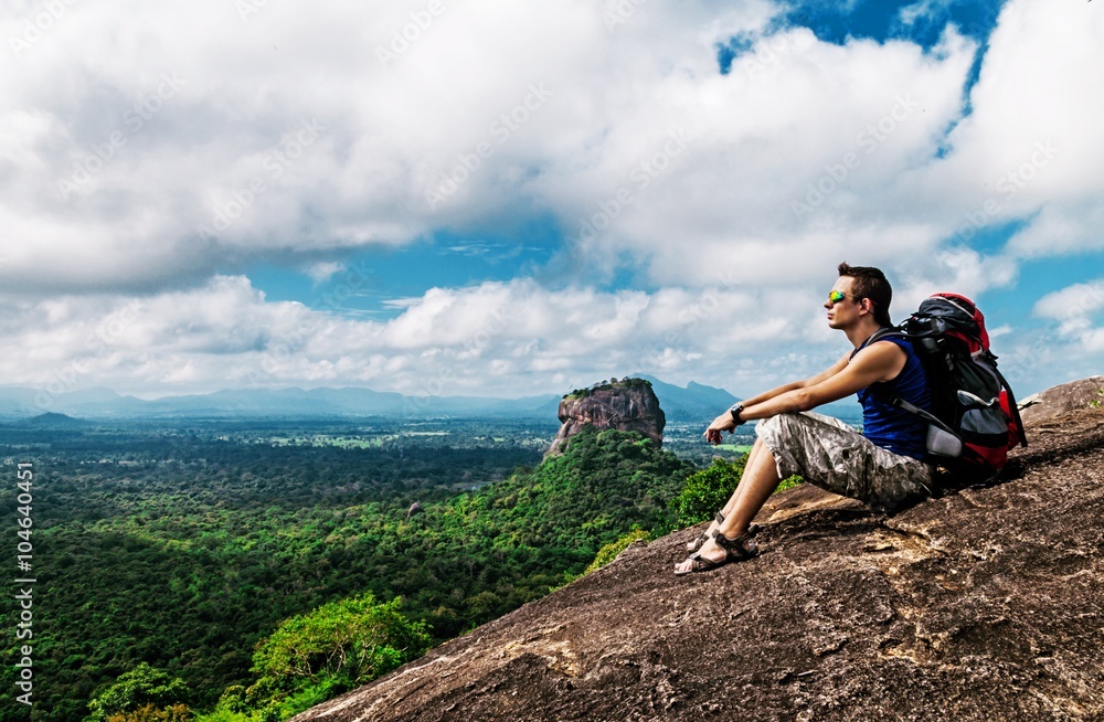 Backpacker on the top of mountain Pidurangala near Sigirya Rock, Sri-Lanka