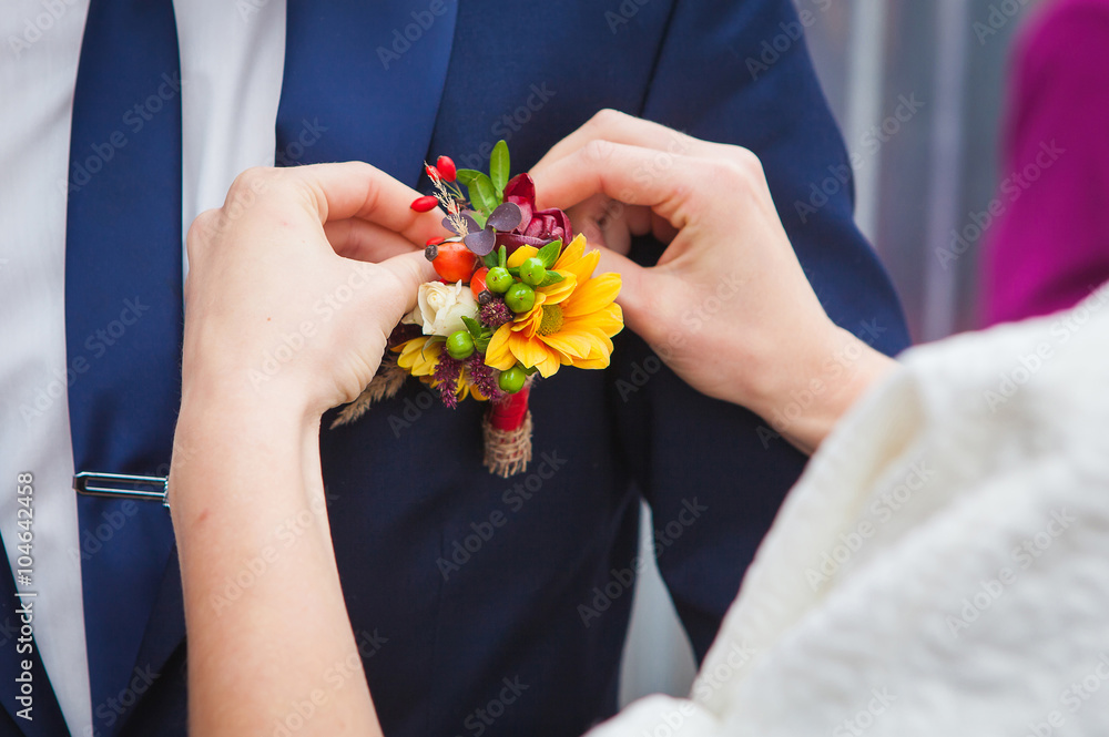 bride groom wears a buttonhole