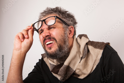 Old Blind grumpy man with beard and big nerd glasses
