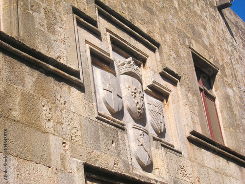 Medieval family crests on a stone wall photo