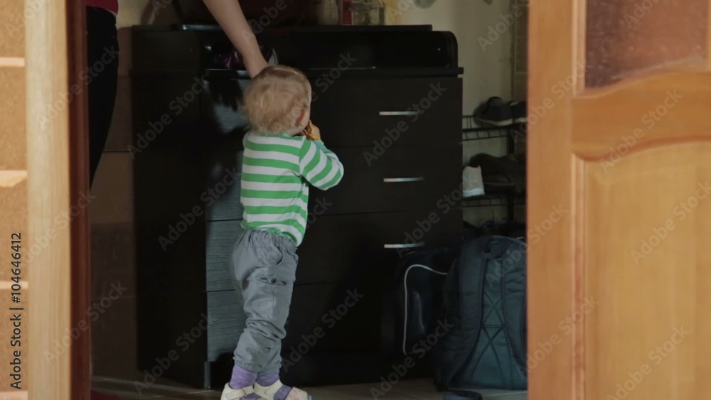 Boy stay near the chest of drawers at home Boy stay near the chest of drawers at home