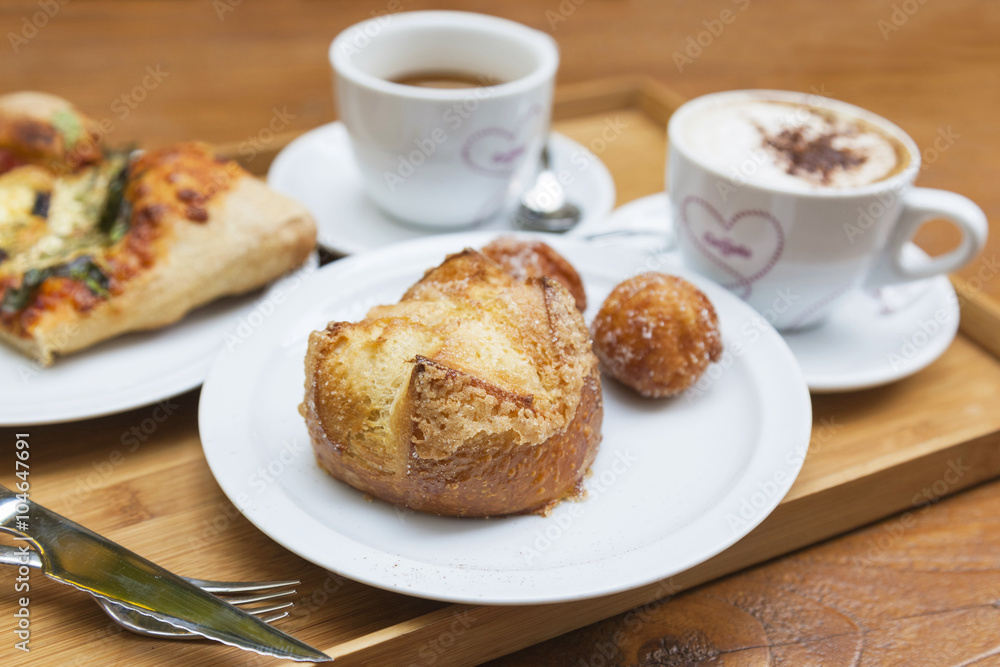 Brioche on background of cups with hearts Brioche on background of cups with hearts