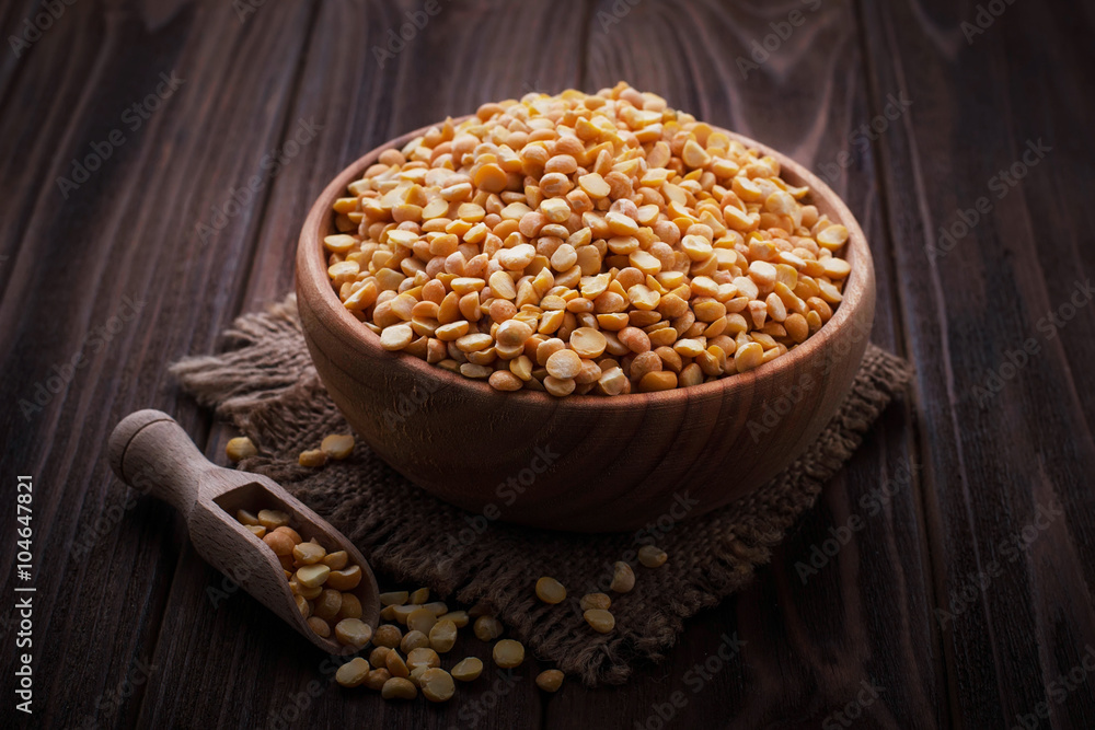 Yellow dry peas in wooden bowl Yellow dry peas in wooden bowl